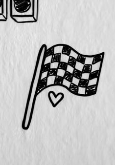 a drawing of a checkered flag next to traffic lights and an alarm clock on a white wall