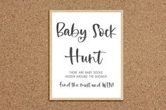 a baby sock hunt sign on a cork board