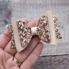 A beautiful medium sized faux leather bow in rose gold glitter perfect hair accessories for baby girls hair or toddler girls hair! Looking for a Valentines Day Gift? This this glitter hair bow is such a lovely gift for girls as a flower girl headband or a spring hair clip - the perfect gift for kids!  b r i e g e + r o s e  hair accessories make excellent gifts for birthdays, new babies and special occasions. They're also the perfect hair accessory for weddings, holidays and parties. All of our Hair Accessories Flower, Flower Girl Headband, Toddler Hairstyles Girl, Flower Girl Headbands, Glitter Hair Bows, Glitter Hair, Leather Bow, Spring Hairstyles