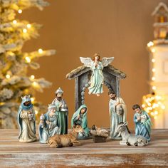 a nativity scene with figurines and lights in the background