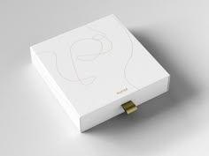 a white box with a gold ring on it