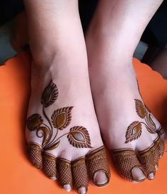 the feet are decorated with flowers and leaves