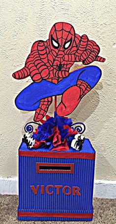 a cardboard box with a spiderman on top and the word victory written in it