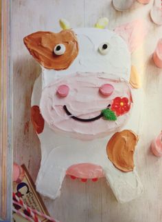 a cake shaped like a cow with flowers on it