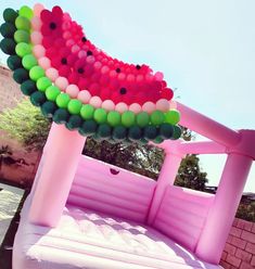 a large inflatable watermelon sitting on top of a pool