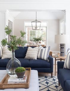 a living room filled with blue couches and pillows