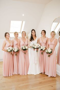 the bride and her bridesmaids pose for a photo in front of their mirrors