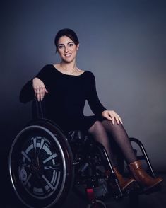 a woman sitting in a wheel chair with her legs crossed