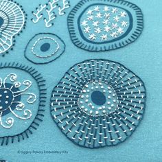 an image of some very pretty designs on something blue and white in the day time