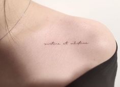 the back of a woman's shoulder with an inscription written in cursive writing