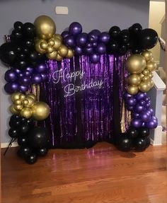 purple and gold balloon arch with happy birthday sign