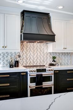 a stove top oven sitting inside of a kitchen next to white cupboards and counter tops