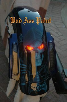 the back end of a motorcycle with an image of a skeleton on it's head