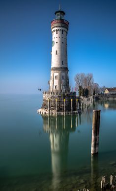 a light house sitting on top of a body of water