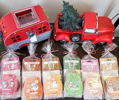 a table topped with plastic bags filled with different types of christmas gifts next to a toy truck