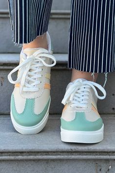 A simple sneaker with pastel colors and a comfortable fit. They are a low ankle sneaker with stripes and laces. Style with a jumpsuit or jeans for a casual look. Heel Height: 1.25" Trendy Green Sneakers For Spring, Casual High-top Platform Sneakers With Elastic Laces, Sporty Striped Lace-up Sneakers, Green Lace-up Platform Sneakers For Spring, Spring Green Lace-up Platform Sneakers, White Casual Platform Sneakers With Elastic Laces, White Platform Sneakers With Elastic Laces, Casual, Casual White Platform Sneakers With Elastic Laces, Casual Summer Jogging Sneakers