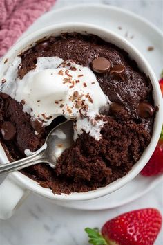 a white bowl filled with chocolate pudding and whipped cream