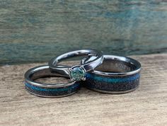 two wedding rings with blue and black glitter on them