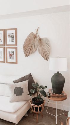 a living room filled with furniture and pictures on the wall