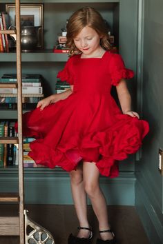 Our Mini Kendy Dress is here! This playful girl's dress features a trendy square neckline and fun short flutter sleeves with ruffle frill detailing. The midi-length skirt also has ruffle frill detailing at the hem for added flair. Made with red organza fabric, this darling dress is lightweight and perfect for any occasion. With a hidden back zipper and double dart detailing on the bodice, this dress not only looks stylish but is also comfortable to wear. A holiday season must-have! Ivy City Co, Fairytale Party, White Dress Party, Darling Dress, Organza Fabric, Midi Length Skirts, Everyday Dresses, Girls Rompers, Flutter Sleeves