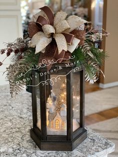 a lighted lantern with a christmas decoration on top