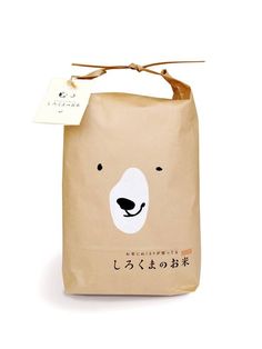 a brown bag with a white bear on it's face and writing in japanese