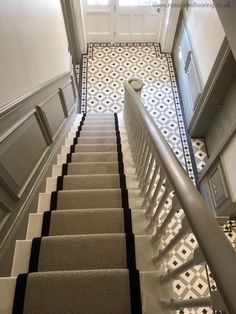 the stairs are lined with black and white tiles