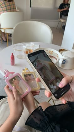 a woman is holding up her cell phone to take a selfie with the baby