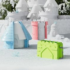 an image of some toys in the snow with trees and buildings behind them that look like they are made out of legos