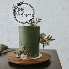 a green cake sitting on top of a wooden plate