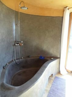 a large bathtub sitting inside of a bathroom next to a window