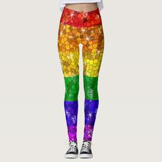 a woman wearing colorful leggings with stars and rainbow colors on the bottom, while she