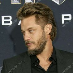 a man with a beard wearing a suit and black shirt at the star trek european premiere