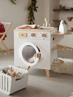 a white washer sitting in front of a christmas tree