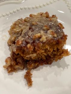 a piece of cake sitting on top of a white plate with a beaded edge