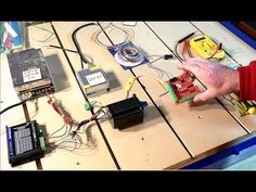 a man is working on an electronic device with wires and other electronics attached to it