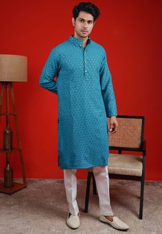 Faux Georgette Kurta in Teal Blue. This Readymade Chinese Collar Neck and Full Sleeve attire is Enhanced with Fancy Buttons, Resham and Sequins Work Available with a Cotton Silk Aligarhi Pant in White Do note: Footwear shown in the image is for presentation purposes only. Half to one inch may vary in measurement. (Slight variation in actual color vs. image is possible) We sell all kinds of menswear. Mens Kurta | Mens Kurta Pajama | Mens Sherwani | Mens Sherwani Sets | Traditional Menswear | Part Festive Light Blue Kurta With Floral Embroidery, Festive Light Blue Kurta For Spring, Light Blue Festive Spring Kurta, Blue Long Sleeve Bollywood Set, Transitional Blue Kurta With Dabka Work, Spring Blue Chikankari Embroidered Kurta, Blue Bollywood Traditional Wear For Spring, Blue Straight Kurta For Festive Occasions, Blue Embroidered Kurta For Diwali