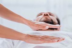 a man laying in bed with his hands on the back of his head as he stretches out