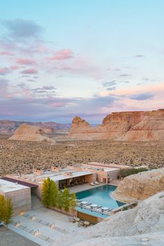 an outdoor pool surrounded by mountains and desert