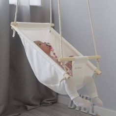 a baby is laying in a hammock swing