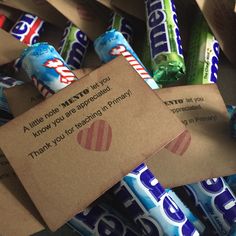 a pile of candy wrapped in brown paper with a note attached to the wrapper