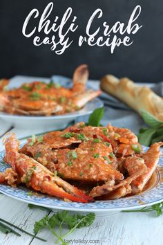 two plates filled with cooked crabs and garnished with parsley on the side