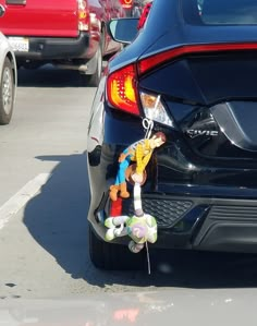 stuffed animals are tied to the trunk of a car