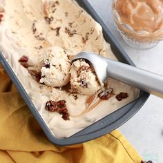 an ice cream sundae with pecans and raisins in it on a tray