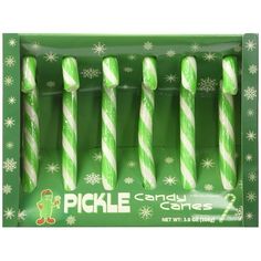 four green and white candy canes in a box