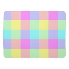 a bath mat with pastel colored squares on the front and back of it,