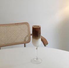 a table with a chair and a drink on it