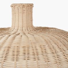 an empty wicker bottle sitting on top of a table