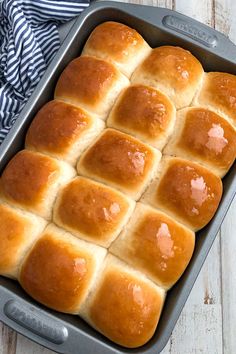 a pan filled with hot cross buns sitting on top of a wooden table