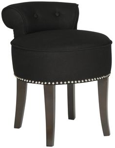 a black upholstered chair with studding on the legs